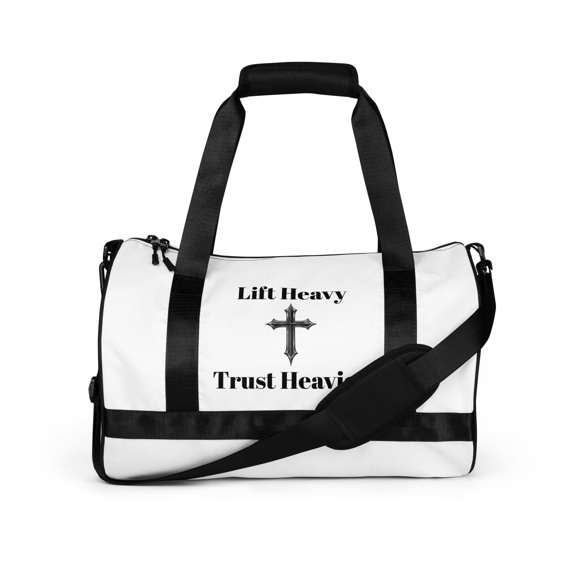 White duffel bag with black straps and 'Lift Heavy Trust Heavy' text and cross design on a white background
