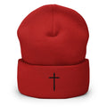 red cuffed beanie with black cross embroidered on the front 