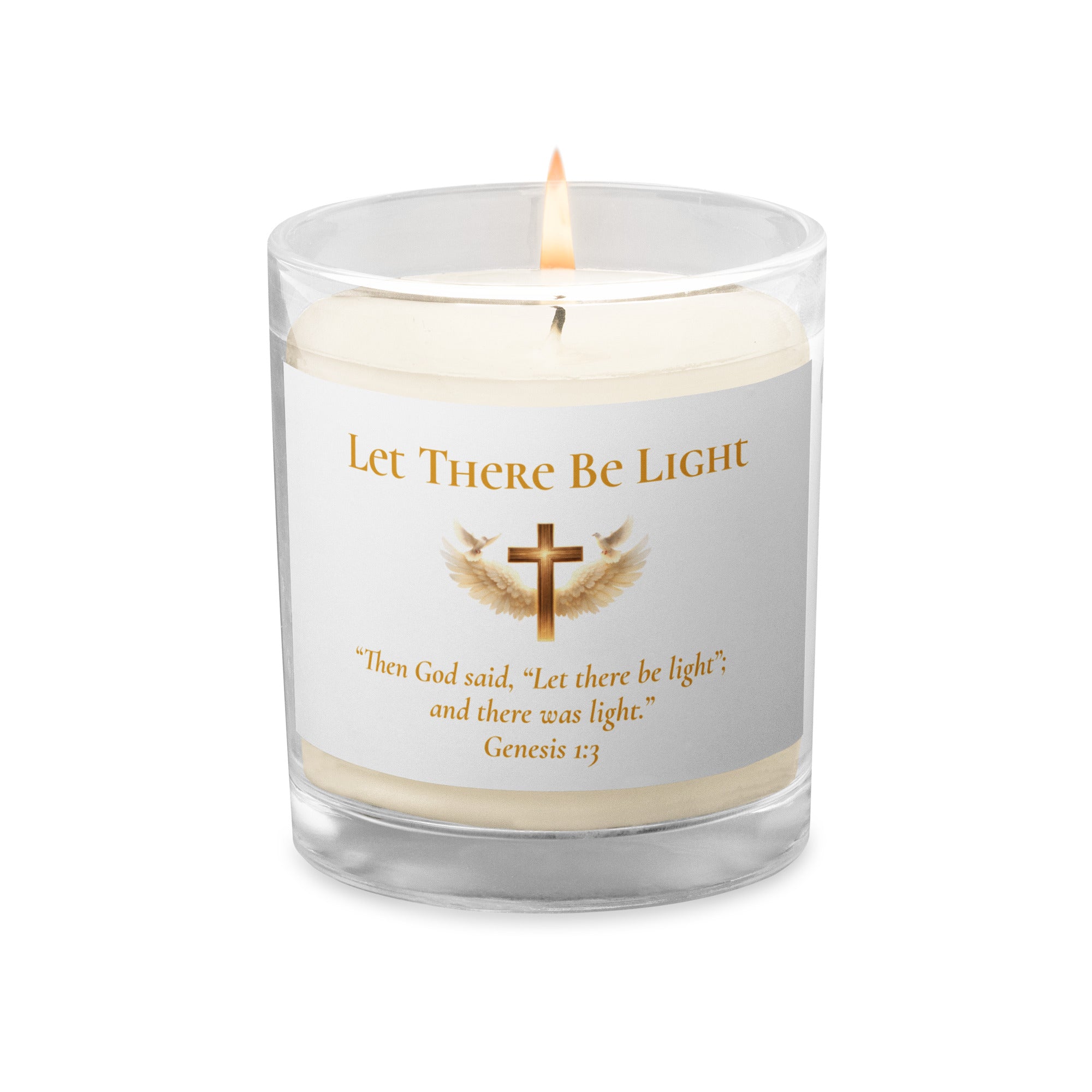 white Christian prayer candle in a clear glass jar with a lit wick decorated with the phrase "Let There Be Light", a gold cross with wings, and the Bible verse Genesis 1:3 printed below.