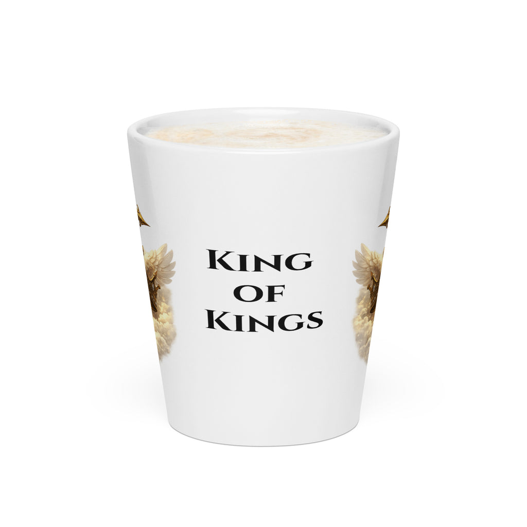 white ceramic Christian mug with the words "King of Kings" printed in black on the side with parts of a gold cross and jeweled crown and angel wings design visible on each side. 