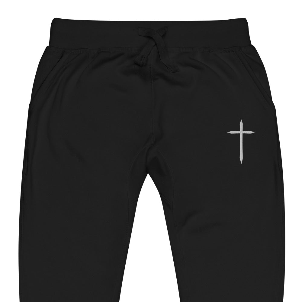 Black pants with a white cross logo on a white background