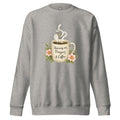 carbon grey sweatshirt with a coffee cup with words that read, "Running on prayers and coffee" featuring steam rising out of cup with a cross hanging off the steam.