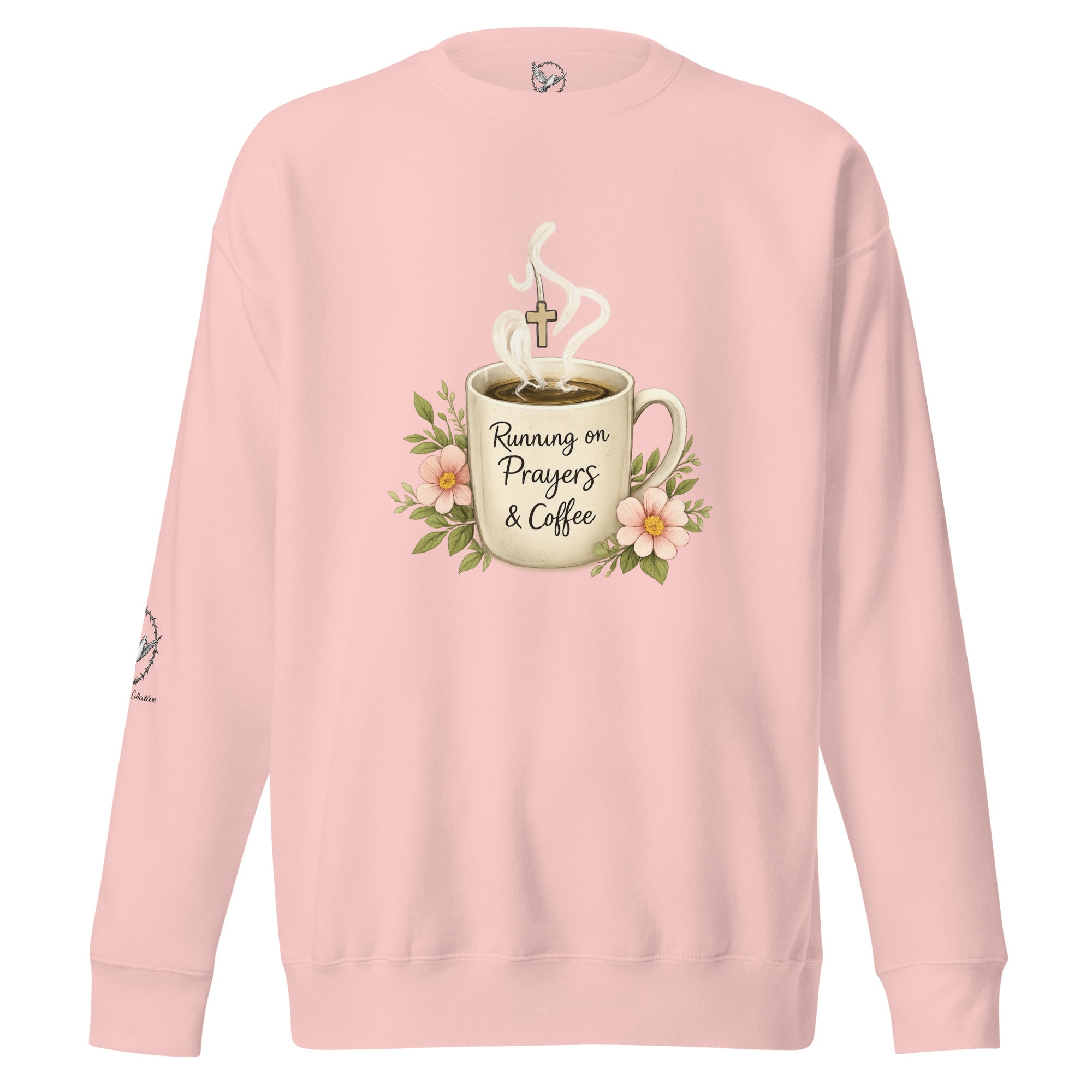 light pink sweatshirt with a coffee cup with words that read, "Running on prayers and coffee" featuring steam rising out of cup with a cross hanging off the steam.