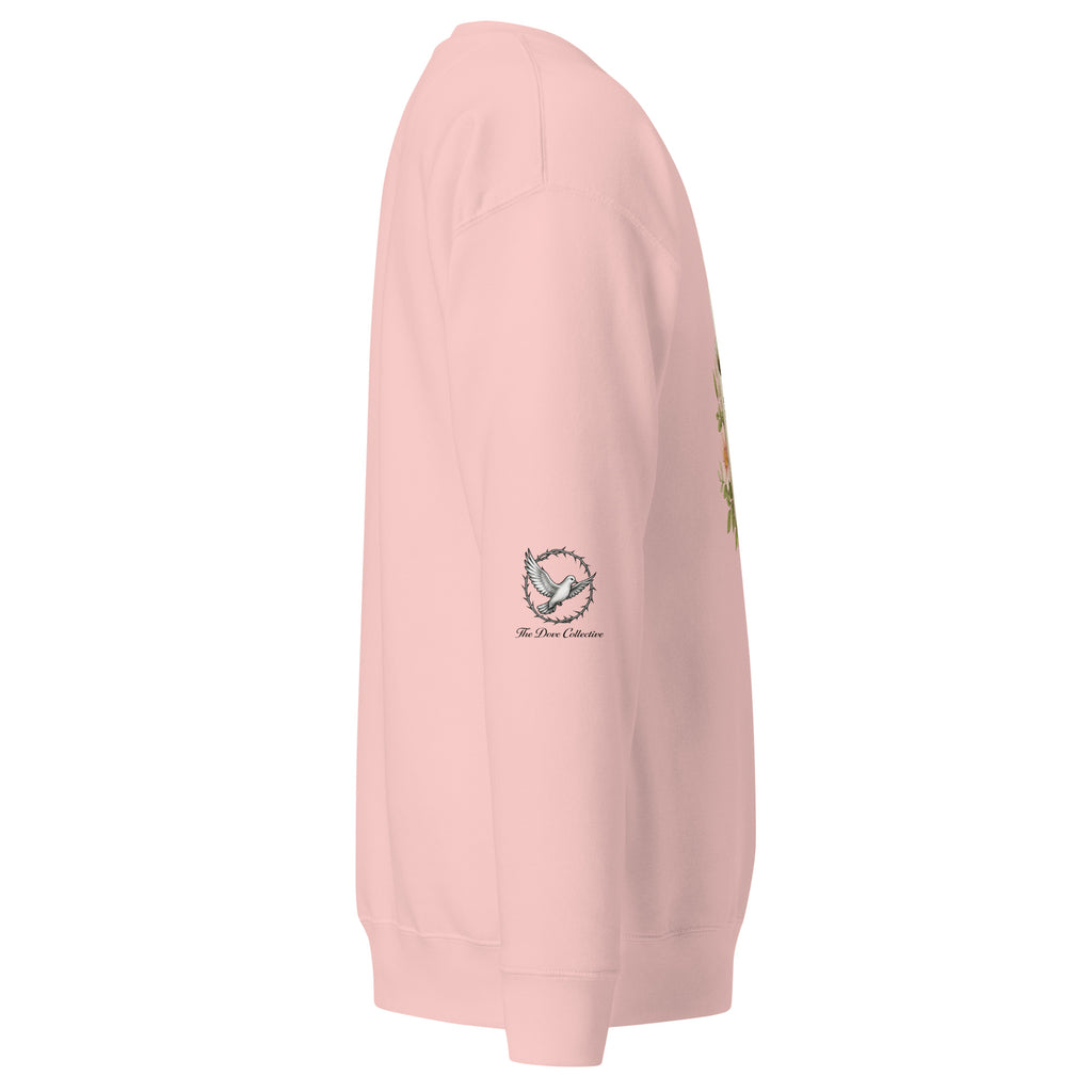 light pink sweatshirt showing the right sleeve with a dove encircled by a crown of thorns. 