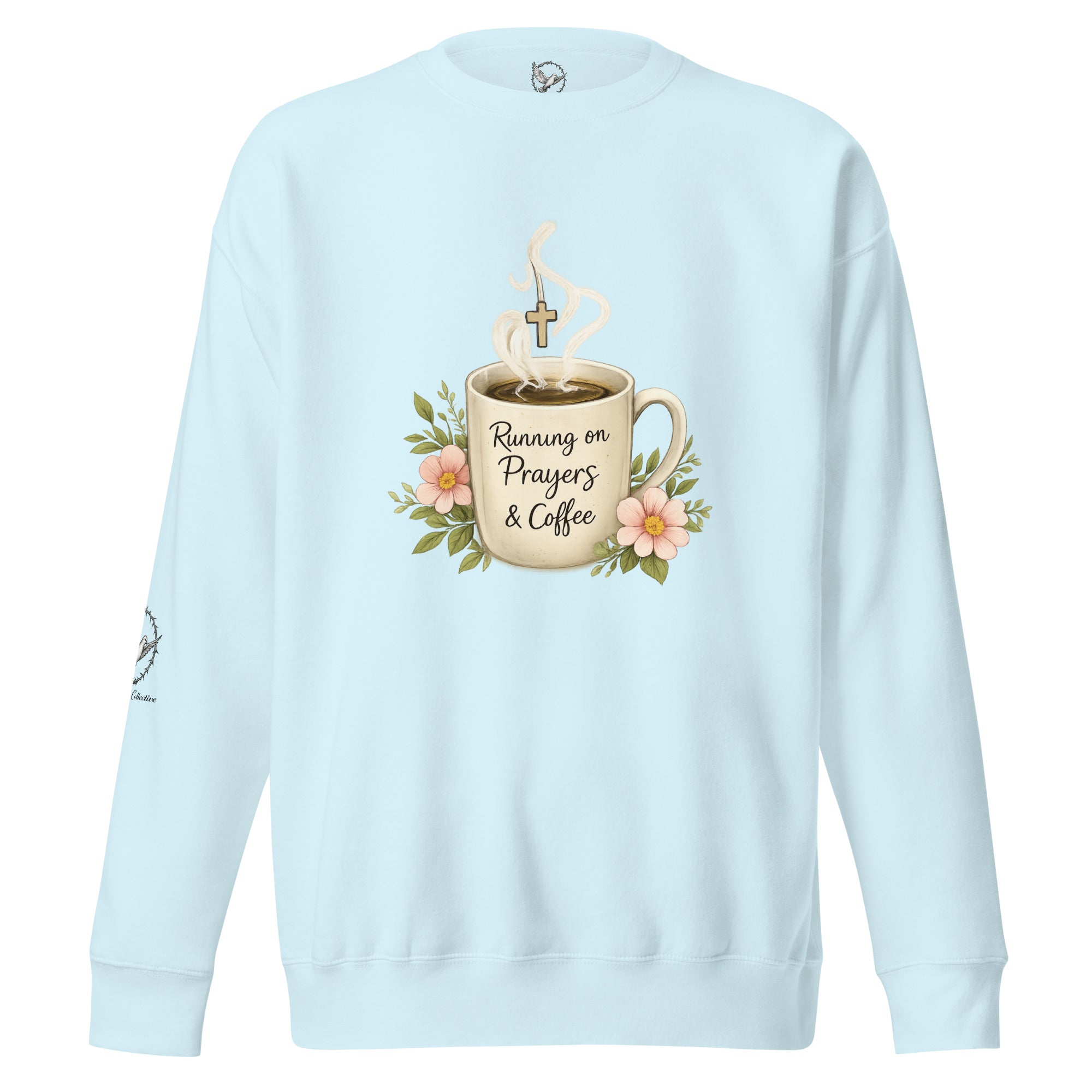 sky blue sweatshirt with a coffee cup with words that read, "Running on prayers and coffee" featuring steam rising out of cup with a cross hanging off the steam.