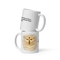 white ceramic Christian mug featuring a glowing gold cross with angel wings and clouds on one side, and the Bible verse "He will cover you with His feathers, and under His wings you will find refuge. Psalm 91:4 printed on the other side. 