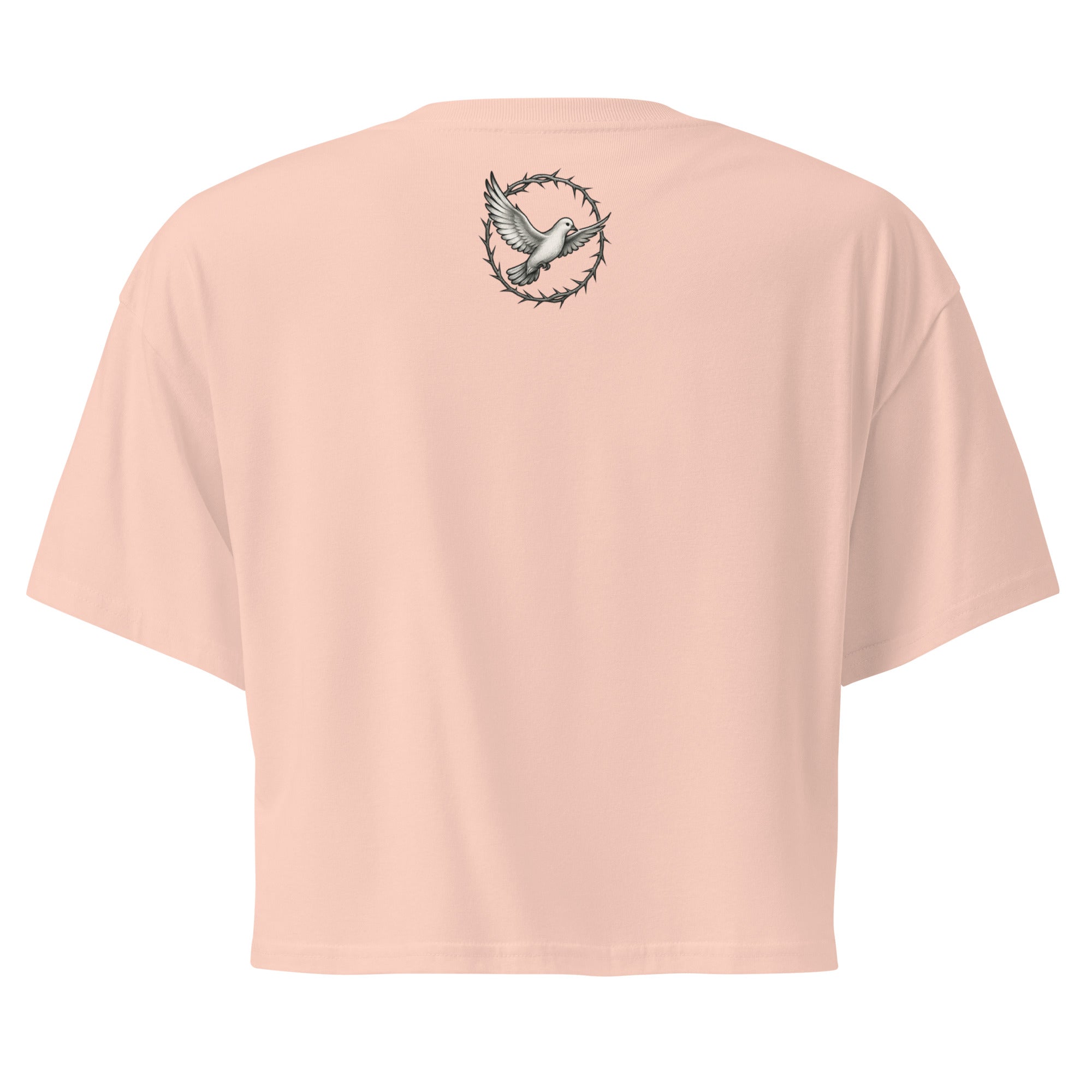  back of a pale pink cropped Christian t-shirt featuring a small white dove centered between the shoulders surrounded by a circular crown of thorns design.