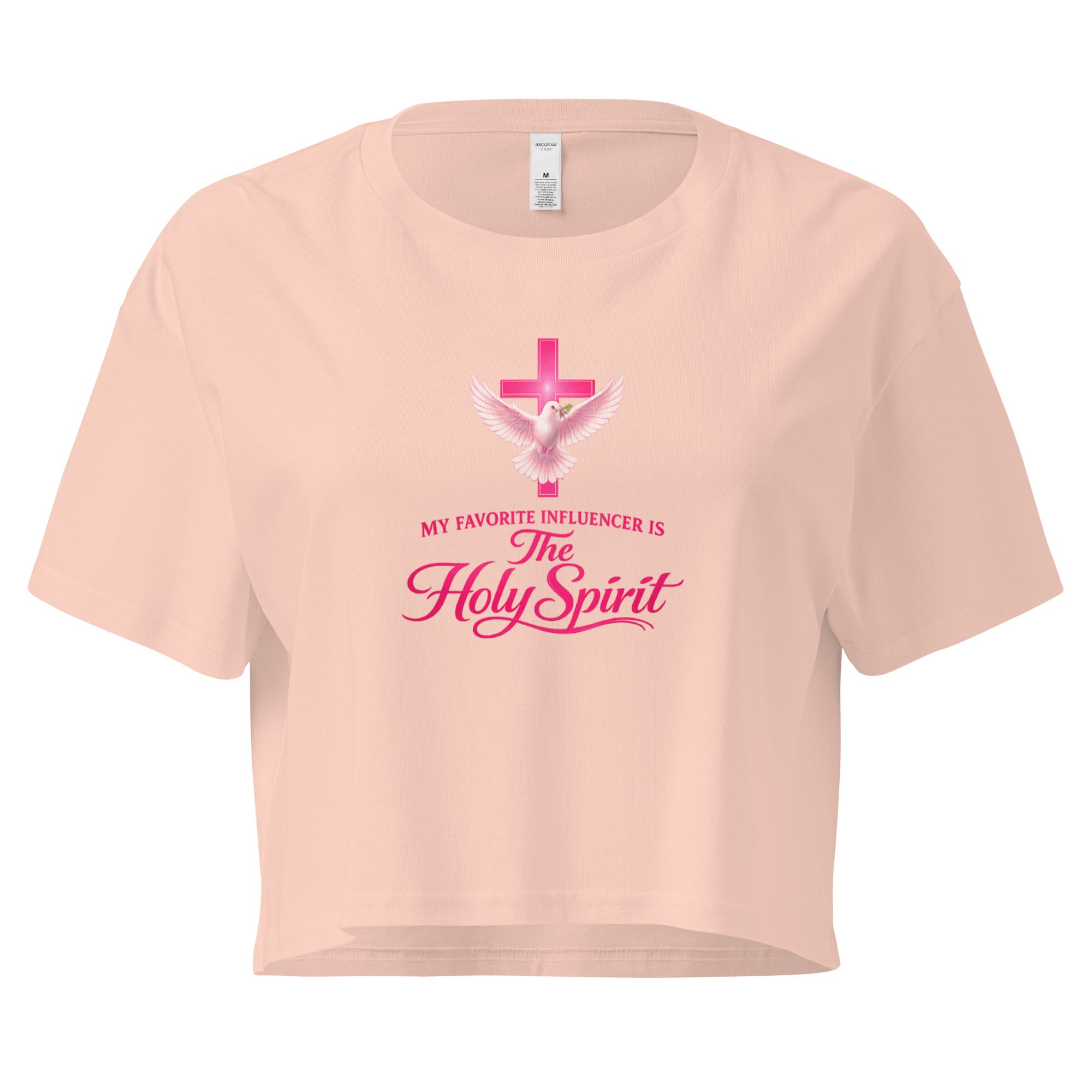 pale pink cropped Christian t-shirt with a pink cross and white dove graphic, featuring the phrase "My favorite influencer is The Holy Spirit" in pink lettering across the front.